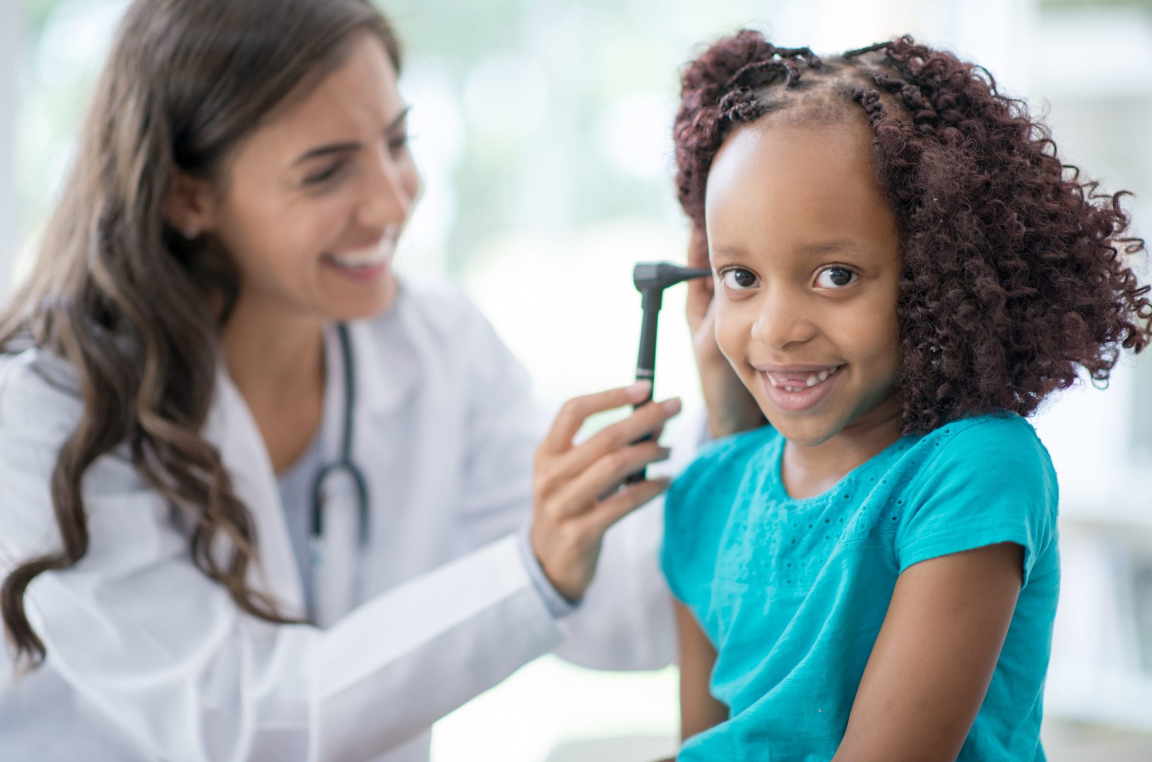 Doctor checking a child for ear infection