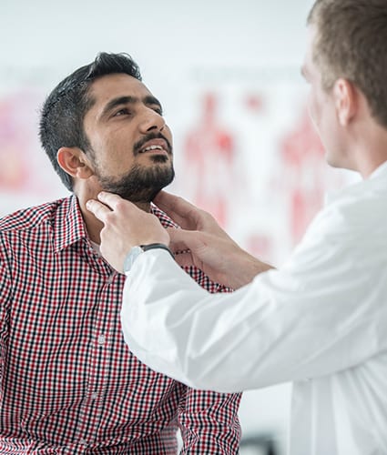 Man getting throat checked as part of chronic and preventative care